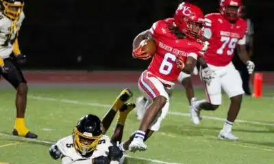 Warren Central player in red jersey evades a tackle during a football game against Greenville, showcasin — 45-6 homecoming