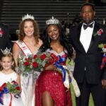 Rey’Nhila Gray crowned homecoming queen surrounded by family and court members on the football field.