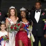 Rey’Nhila Gray crowned homecoming queen surrounded by family and court members on the football field.
