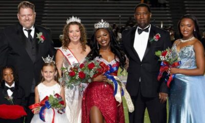 Rey’Nhila Gray crowned homecoming queen surrounded by family and court members on the football field.