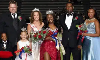 Rey’Nhila Gray crowned homecoming queen surrounded by family and court members on the football field.