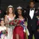 Rey’Nhila Gray crowned homecoming queen surrounded by family and court members on the football field.