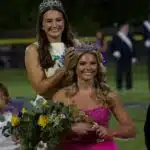 Hendrix Eldridge crowned homecoming queen wearing a pink dress and tiara, with a girl — Hendrix Eldridge Homecoming queen