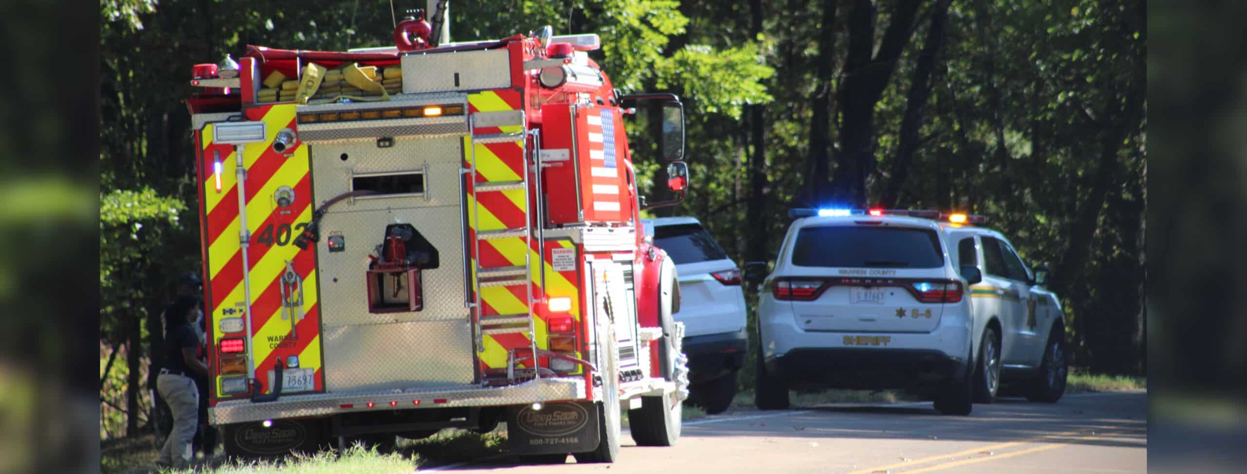 Emergency vehicles at the scene of a UTV accident in Warren County, with a fire truck and police cars visib — Child killed