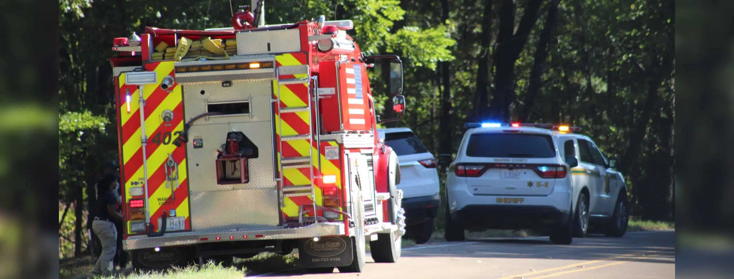 Emergency vehicles at the scene of a UTV accident in Warren County, with a fire truck and police cars visib — Child killed