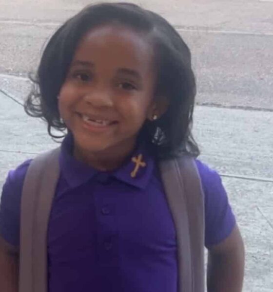 Paris Morris smiling in a purple school uniform with a backpack