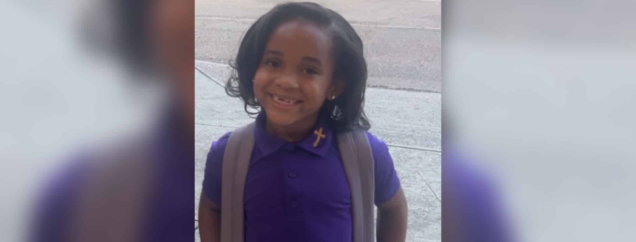 Paris Morris smiling in a purple school uniform with a backpack