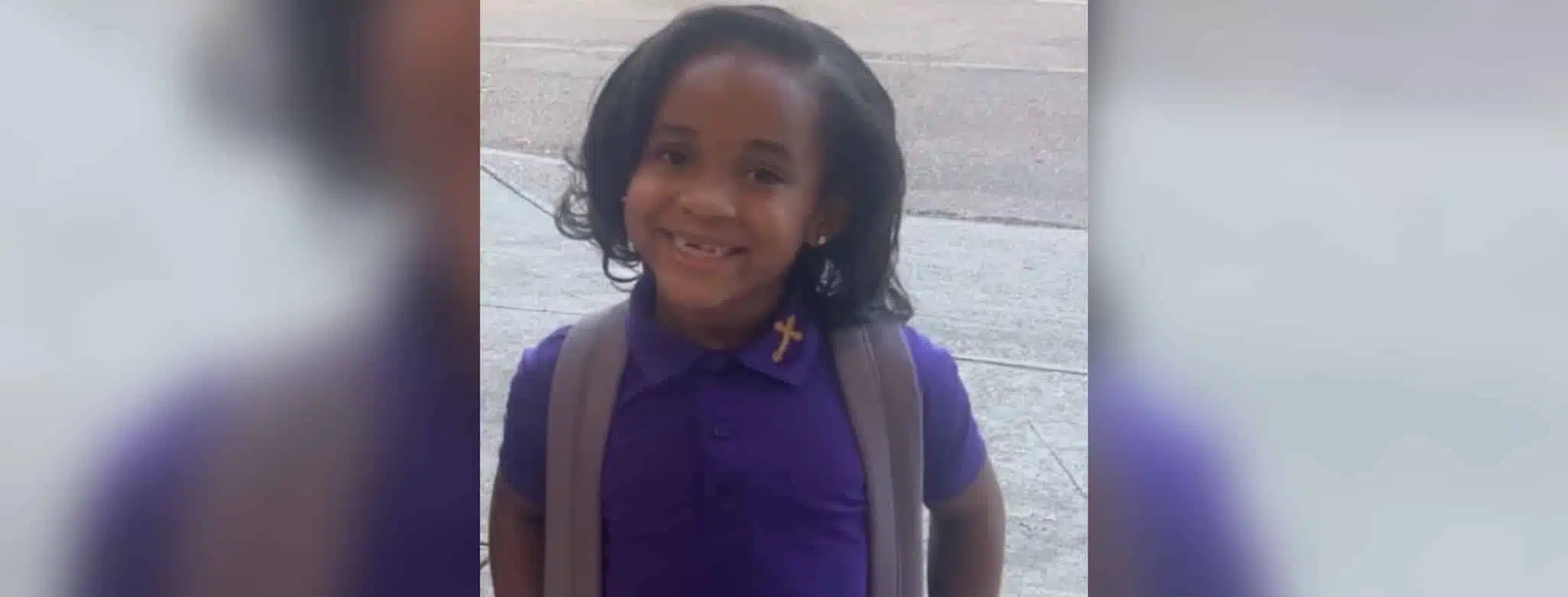 Paris Morris smiling in a purple school uniform with a backpack