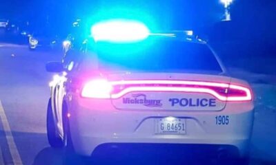 Vicksburg police car with flashing lights on a dark street Sunday night