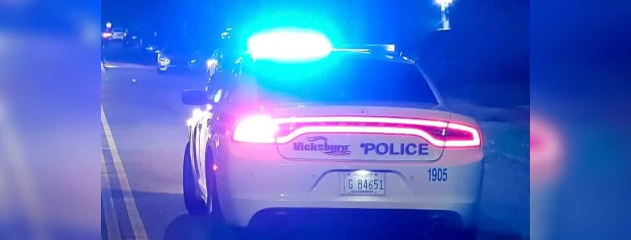 Vicksburg police car with flashing lights on a dark street Sunday night