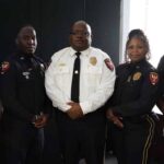 Five uniformed police officers pose together, including one in a white shirt, after Crisis training.