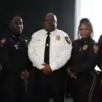 Five uniformed police officers pose together, including one in a white shirt, after Crisis training.