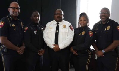 Five uniformed police officers pose together, including one in a white shirt, after Crisis training.