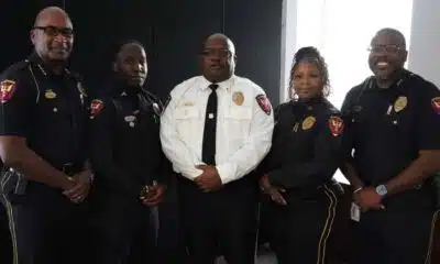 Five uniformed police officers pose together, including one in a white shirt, after Crisis training.