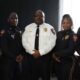 Five uniformed police officers pose together, including one in a white shirt, after Crisis training.