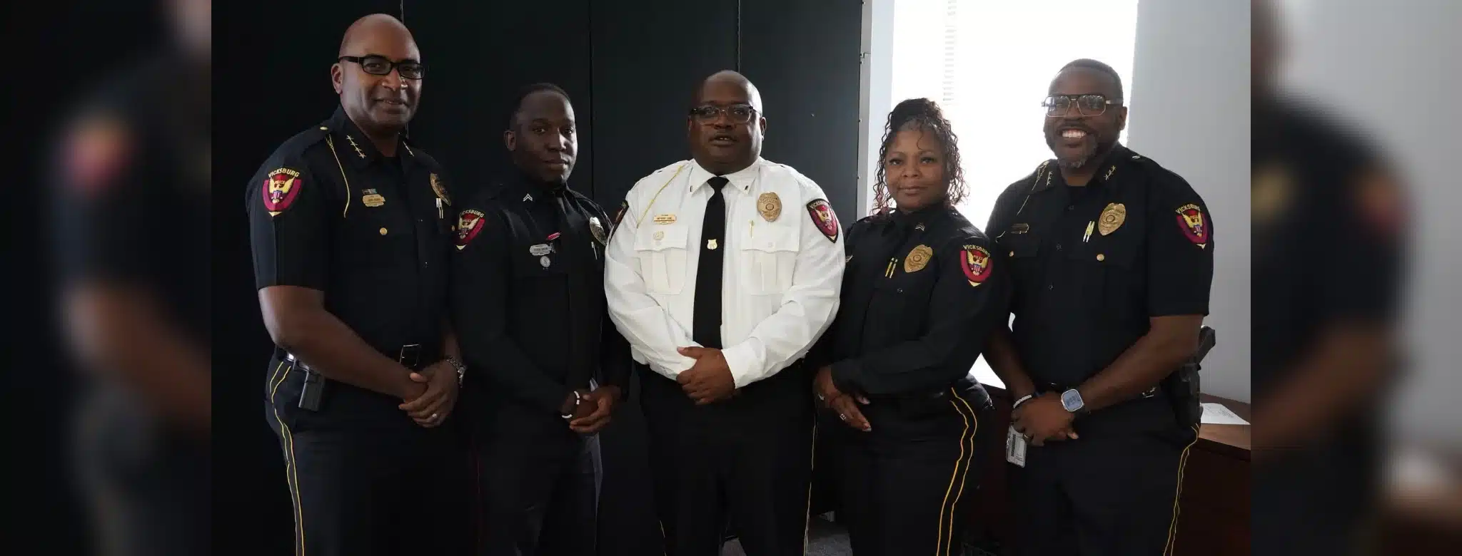 Five uniformed police officers pose together, including one in a white shirt, after Crisis training.