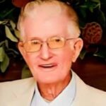 Portrait of Charles Byrden Landers wearing glasses and a light-colored suit jacket