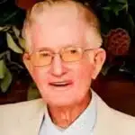 Portrait of Charles Byrden Landers wearing glasses and a light-colored suit jacket