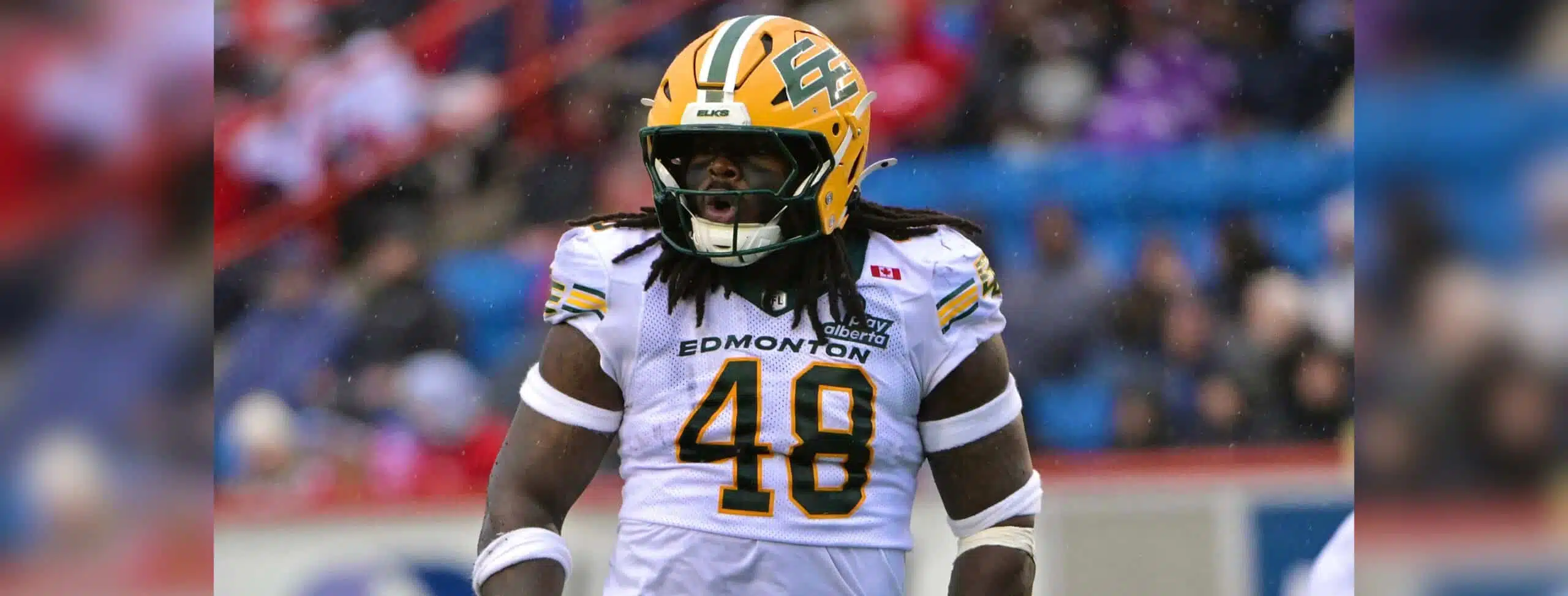 Nick Anderson overcomes injuries as an Edmonton Elks linebacker in a white No. 48 uniform and yellow helmet on the field.
