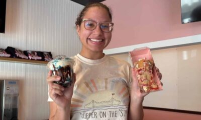Punkies Dessert Lounge owner smiles while holding two — Punkies Dessert Lounge going mobile with addition of food trailer