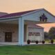 King Solomon Baptist Church entrance and sign on a green lawn at sunset