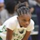Genesis Phelps leads VJHS to a win over Pearl on Thursday as a Vicksburg player crouches on the basketball court.