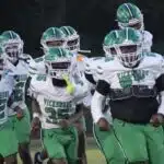 Vicksburg Gators football team running onto the field in green and wh — Gators take a 15-12 heartbreaking loss to Florence