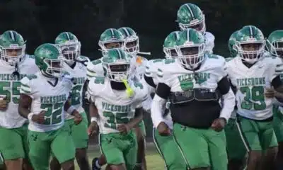 Vicksburg Gators football team running onto the field in green and wh — Gators take a 15-12 heartbreaking loss to Florence