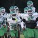 Vicksburg Gators football team running onto the field in green and wh — Gators take a 15-12 heartbreaking loss to Florence