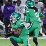 Gators 28-26 Cleveland Central: Vicksburg players in green uniforms celebrate on the field as opponents look on.