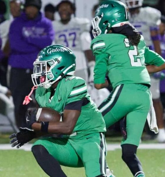 Gators 28-26 Cleveland Central: Vicksburg players in green uniforms celebrate on the field as opponents look on.