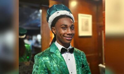 Jordan Clay homecoming king in a green patterned suit, bow tie and crown